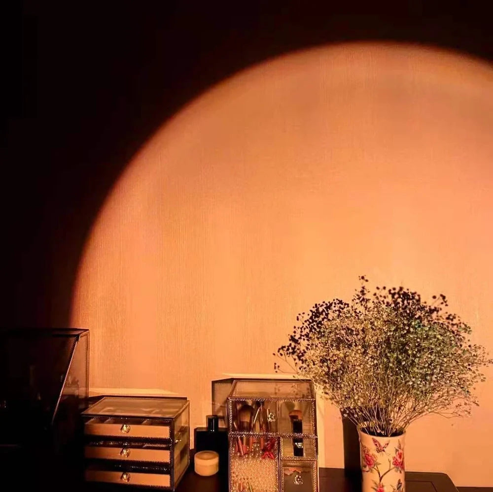 Rechargeable sunset projection lamp showing red and rainbow colours on wall