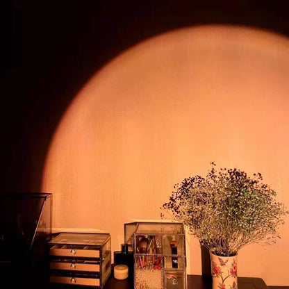 Rechargeable sunset projection lamp showing red and rainbow colours on wall