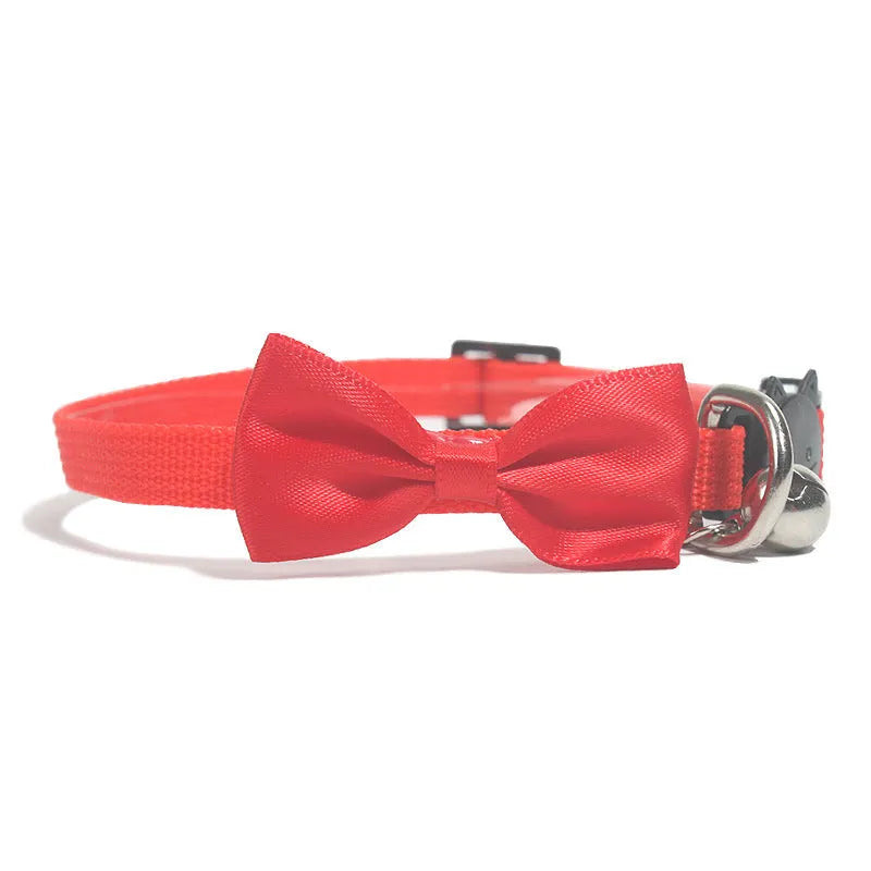 Striped nylon cat collar with decorative bow and bell in multiple colour options on a white background.