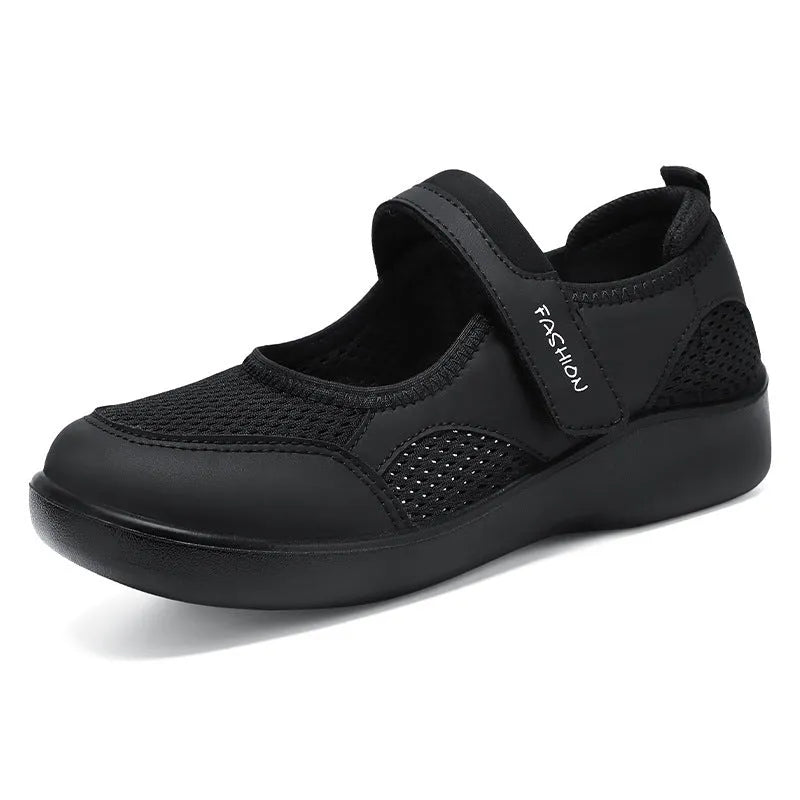 Women's grey velcro casual shoes with mesh upper and flat sole.