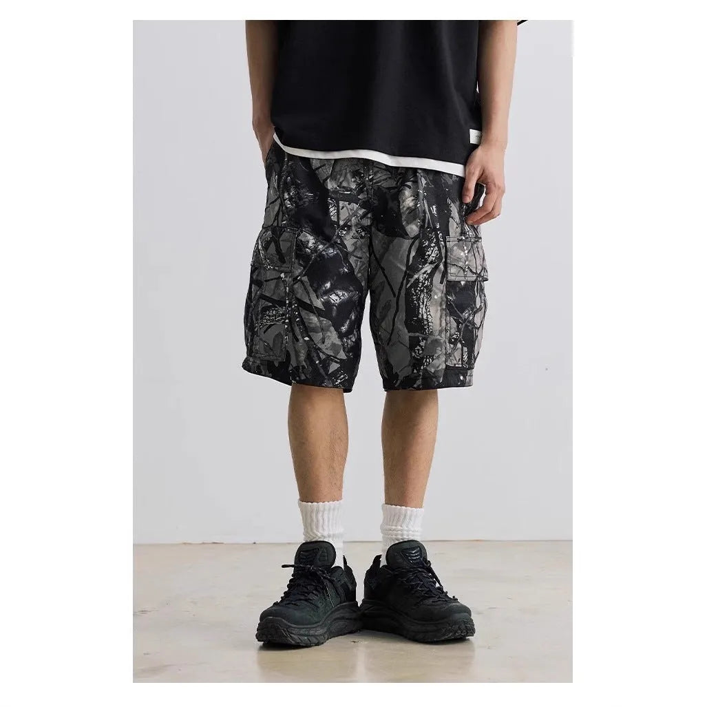 Loose straight-leg denim shorts for teenagers in army green, showing elastic waistband and zip fly.