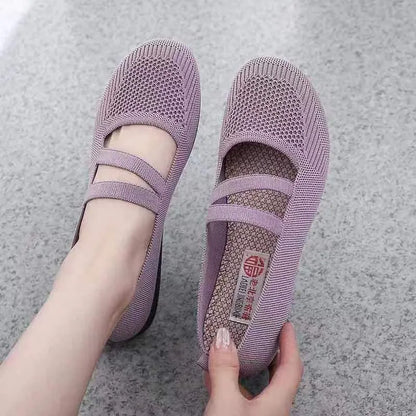 A pair of slip-on flat shoes with an elastic upper and rubber sole, shown in an embroidered colour option.