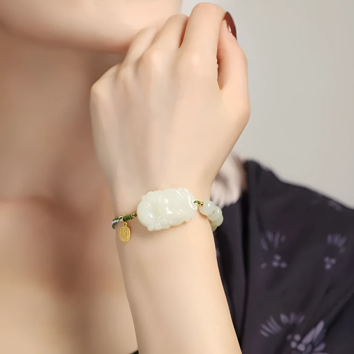 Hetian jade bracelet with a rabbit zodiac charm and S925 silver card on a red ice cotton rope.