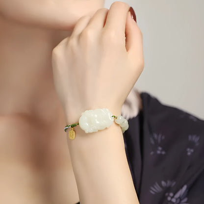 Hetian jade bracelet with a rabbit zodiac charm and S925 silver card on a red ice cotton rope.