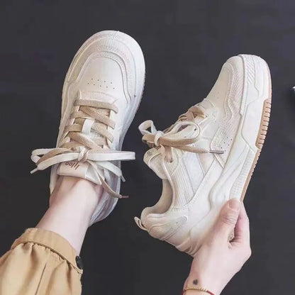 Women's beige and pink low-top sneakers with a rubber sole featuring hidden height increase.