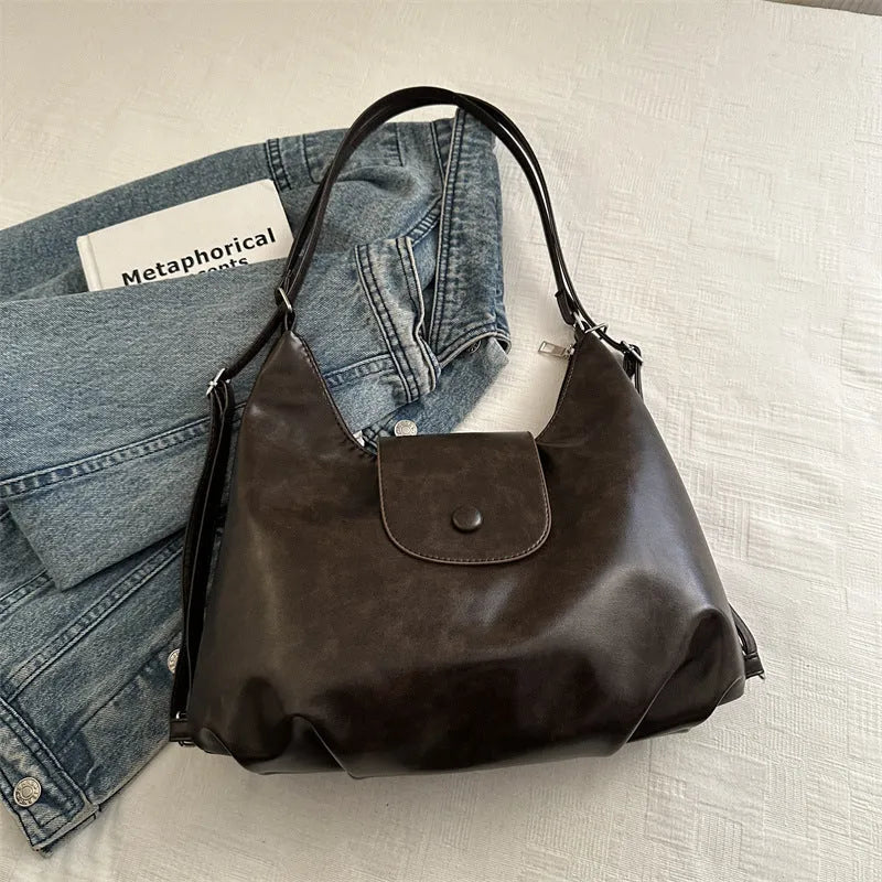 Textured PU leather women's shoulder bag in black with single strap and optional pendant