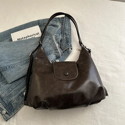 Textured PU leather women's shoulder bag in black with single strap and optional pendant