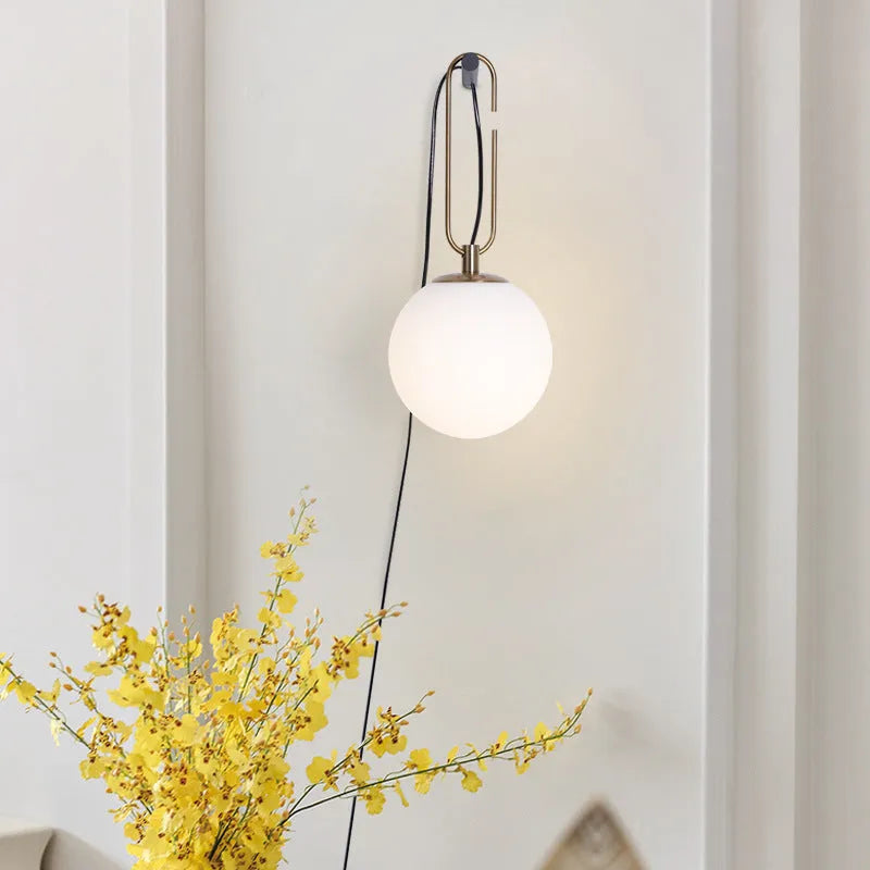 Modern glass wall lamp mounted on a wall, showcasing its clean design and adjustable light colour options.