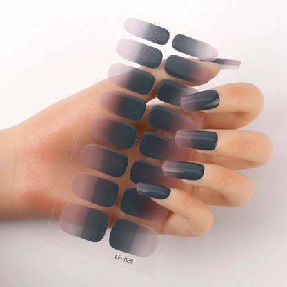 Sheet of 16 small design nail art stickers including cross, rose, tulip and marble patterns.