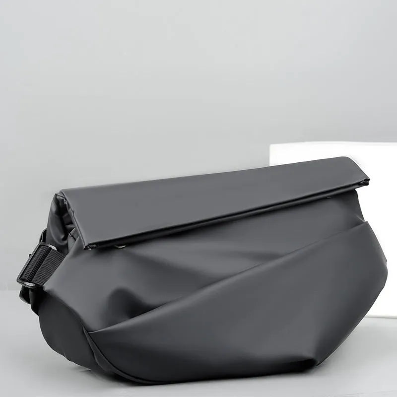 Grey crossbody bag with single shoulder strap showing zipper opening and internal organisation pockets