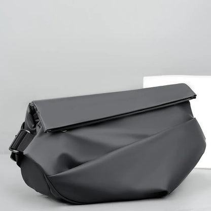 Grey crossbody bag with single shoulder strap showing zipper opening and internal organisation pockets