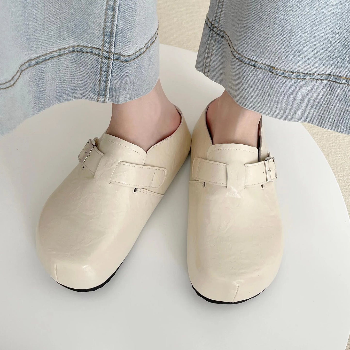 Flat buckle casual sneakers in beige, black, silver, and yellow colours, showing round toe and PU upper.
