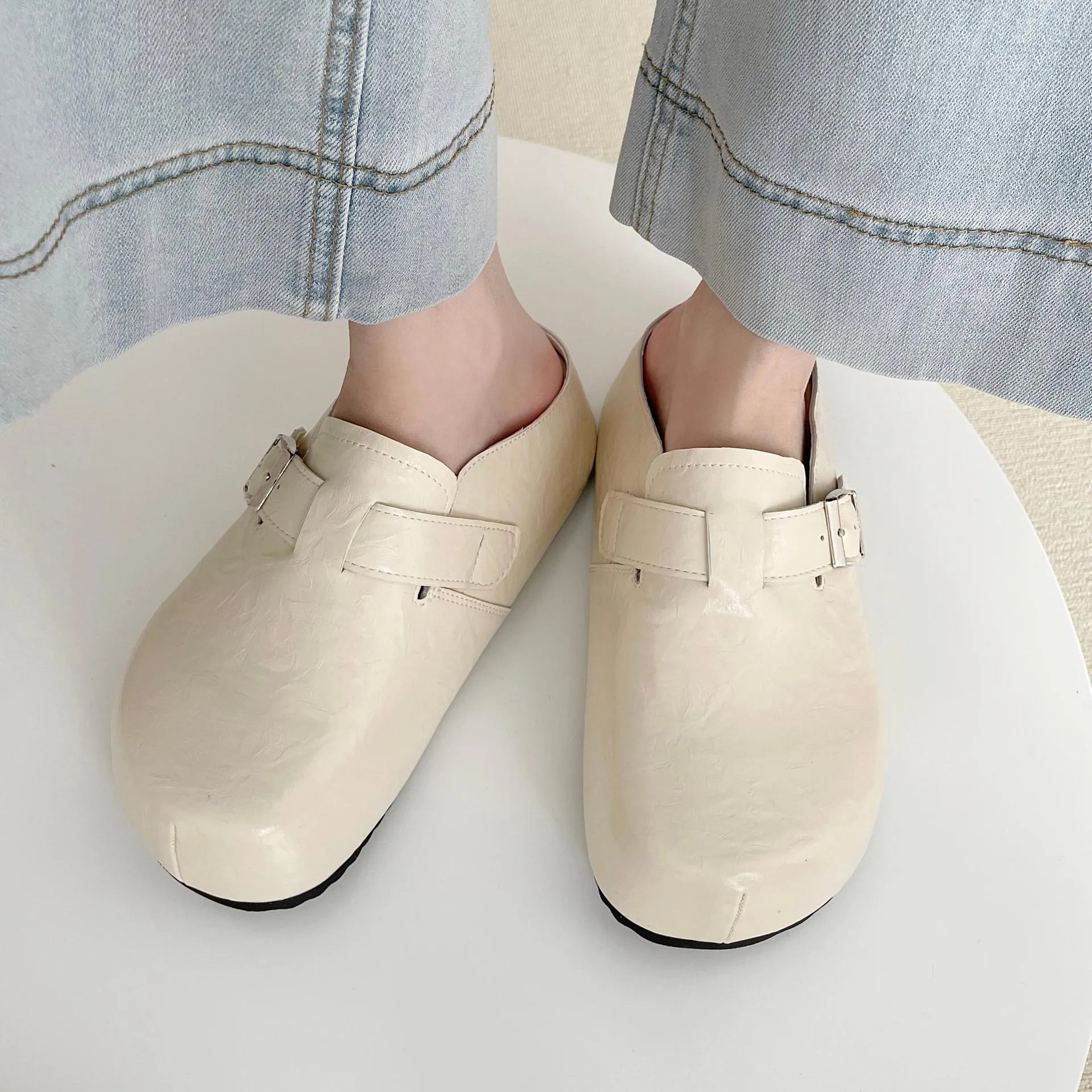 Flat buckle casual sneakers in beige, black, silver, and yellow colours, showing round toe and PU upper.