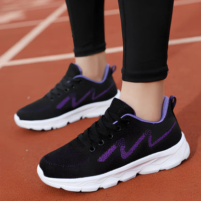 Women's black sneakers with mesh upper, wedge heel, and lace-up front