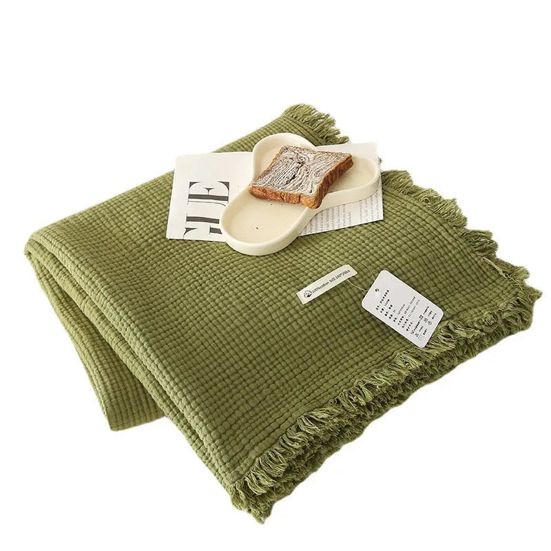 Four-layer gauze tassel blanket in cotton, showing tassel edges and textured fabric, available in multiple colours and sizes