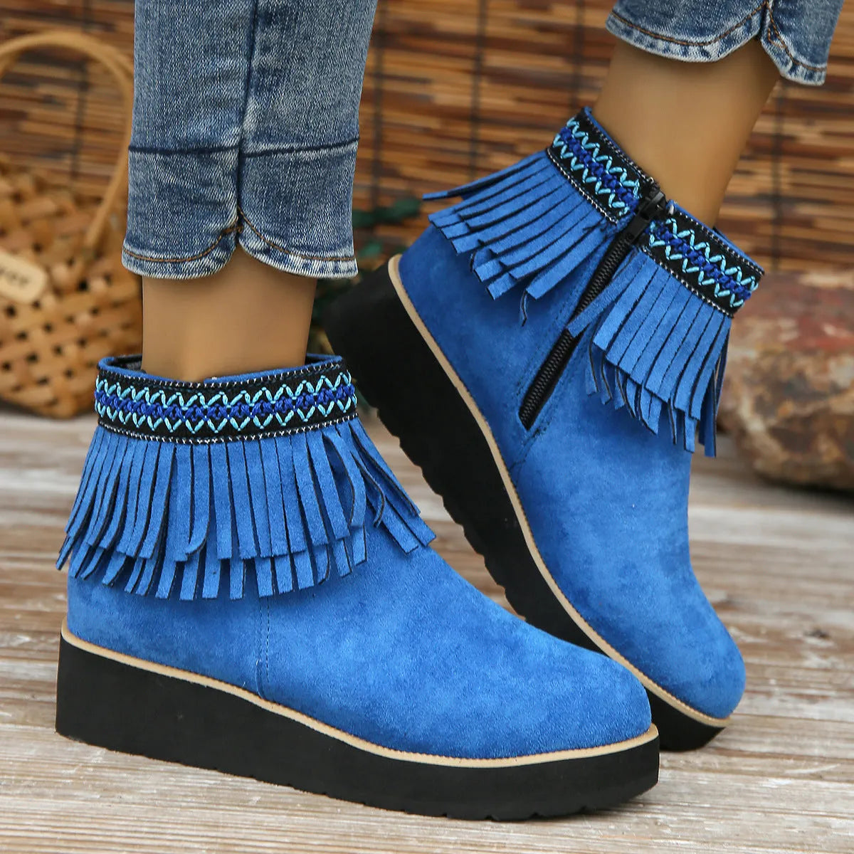 Women's thick bottom wedge bootie in suede with side zipper and tassel detail, available in multiple colours.