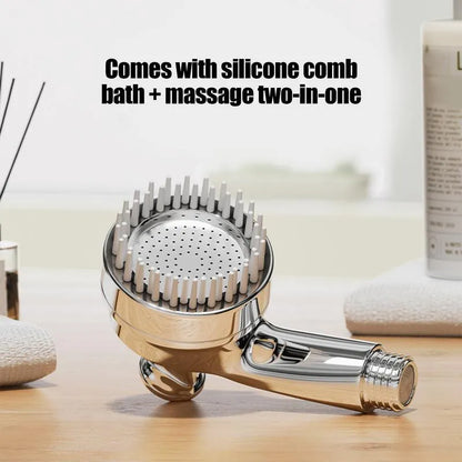 Silver dog shower attachment with silicone comb teeth and ergonomic grip for pet bathing.