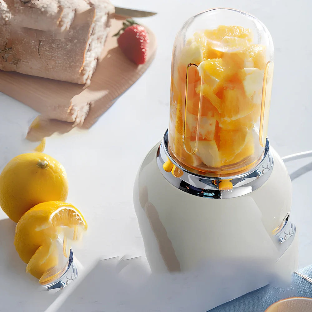 Small portable fruit juicer in blue with 400mL capacity cup and charging cable