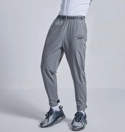 Women's loose sports cropped pants in grey with printed waistband for workouts and running activities