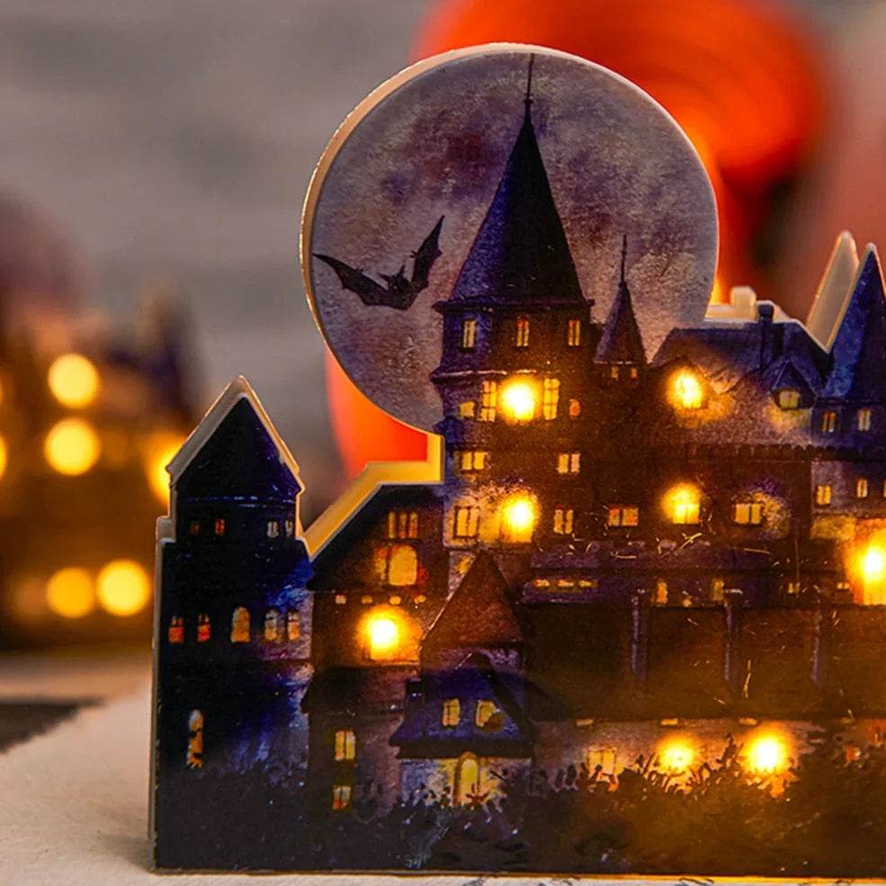 LED illuminated castle ornament with turrets and textured surfaces on desktop