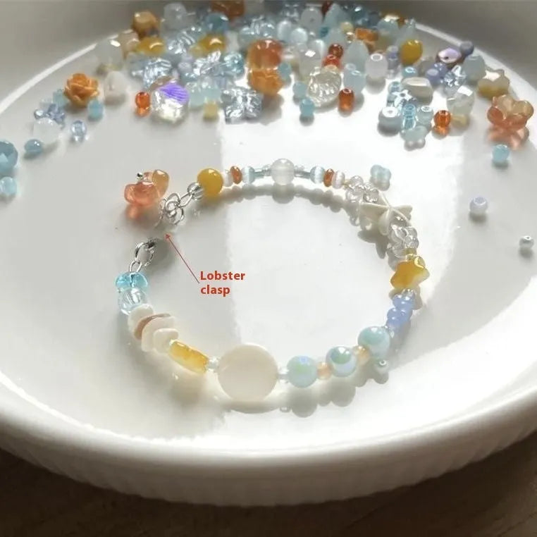 Women's orange mixed material bracelet with a diamond shape and round decorative elements.