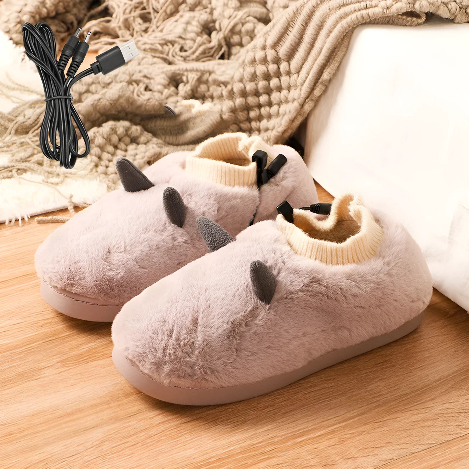 USB-powered electric slippers in black with a connected USB cable, showing soft velvet upper and plastic sole.
