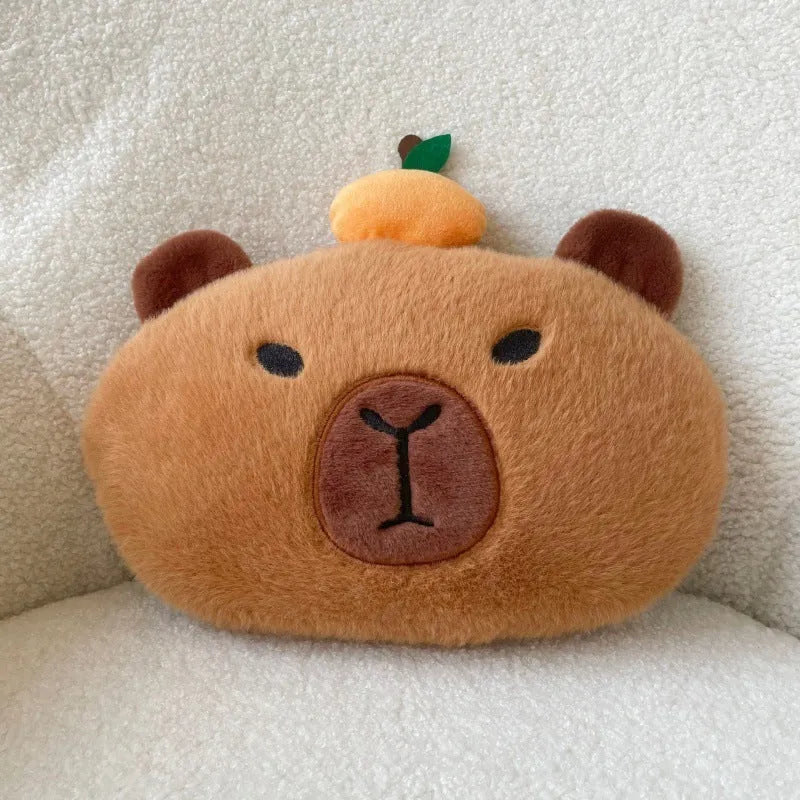 Khaki capybara car pillow in artificial plush with synthetic fibre filling, shown as a car neck pillow or shoulder cover.