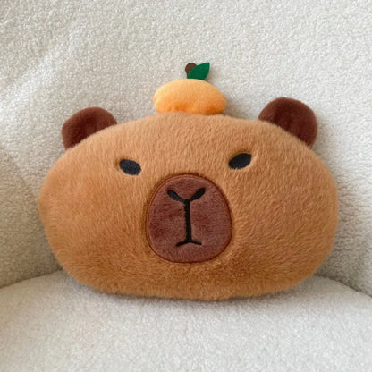Khaki capybara car pillow in artificial plush with synthetic fibre filling, shown as a car neck pillow or shoulder cover.