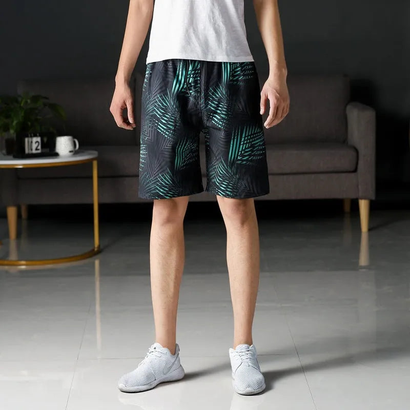 Man wearing loose-fitting striped beach pants made from quick-dry ice silk fabric.