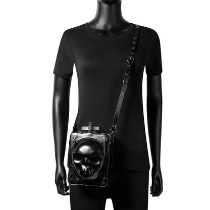 Black mini square messenger bag with embossed skull design, metal chains, and crossbody strap