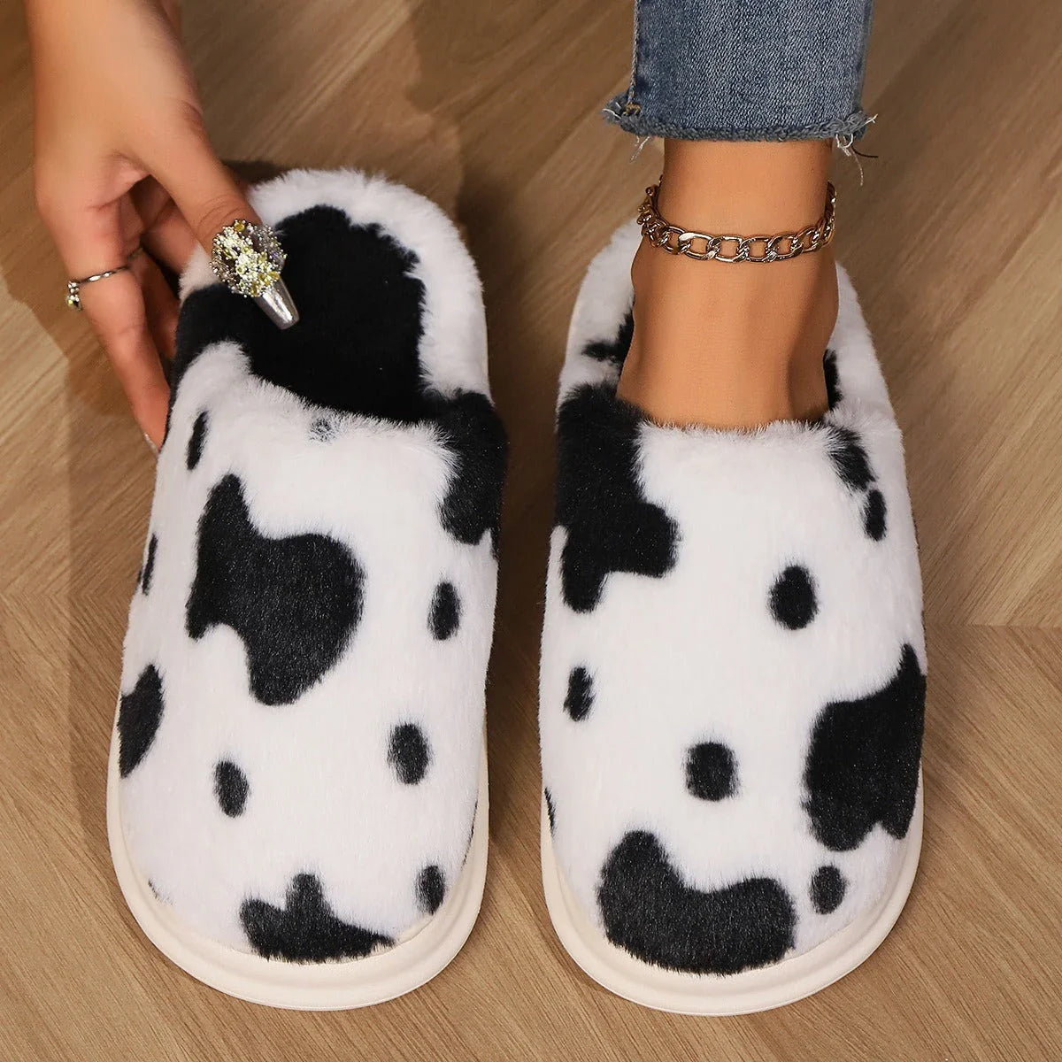 Cozy plush cow-print slippers with non-slip soles for comfortable indoor wear