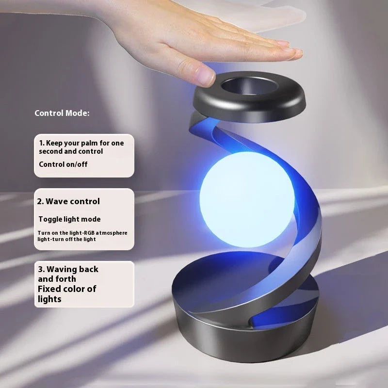 A rotating moon-shaped desk lamp with a wireless charging pad for smartphones, featuring a sleek and modern design.