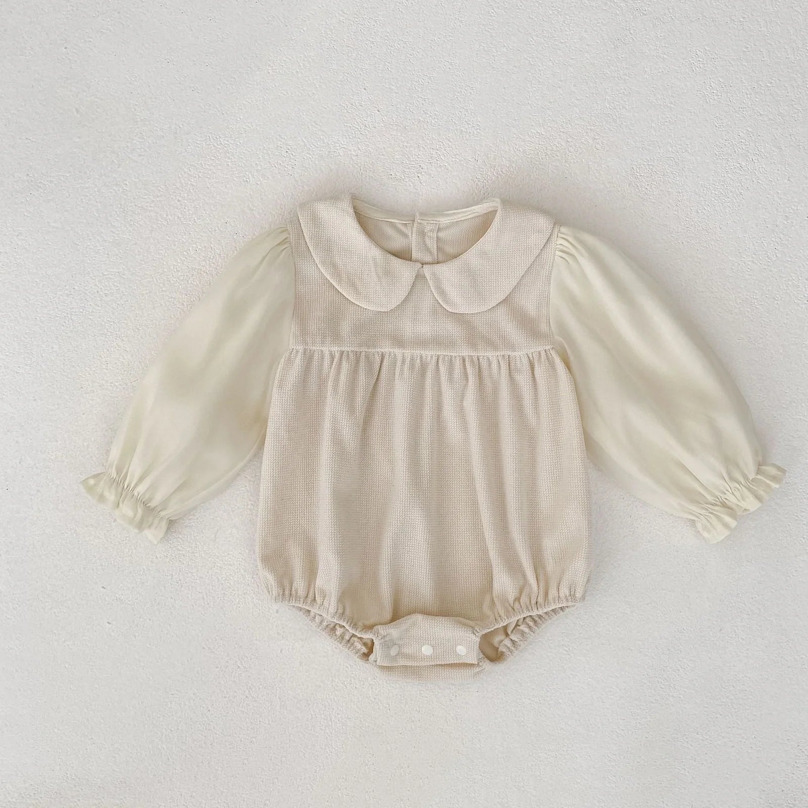 Corduroy doll collar long sleeve baby romper in black or apricot with single-breasted closure