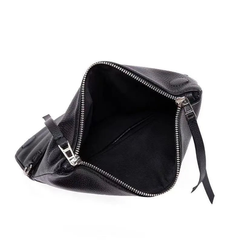 Soft black PU leather women's clutch bag with a gold chain strap, shown held and worn cross-body.