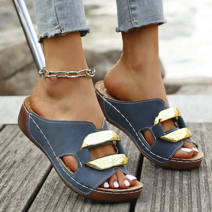 Roman style platform sandals in black with a flat heel and metal detail on the strap.