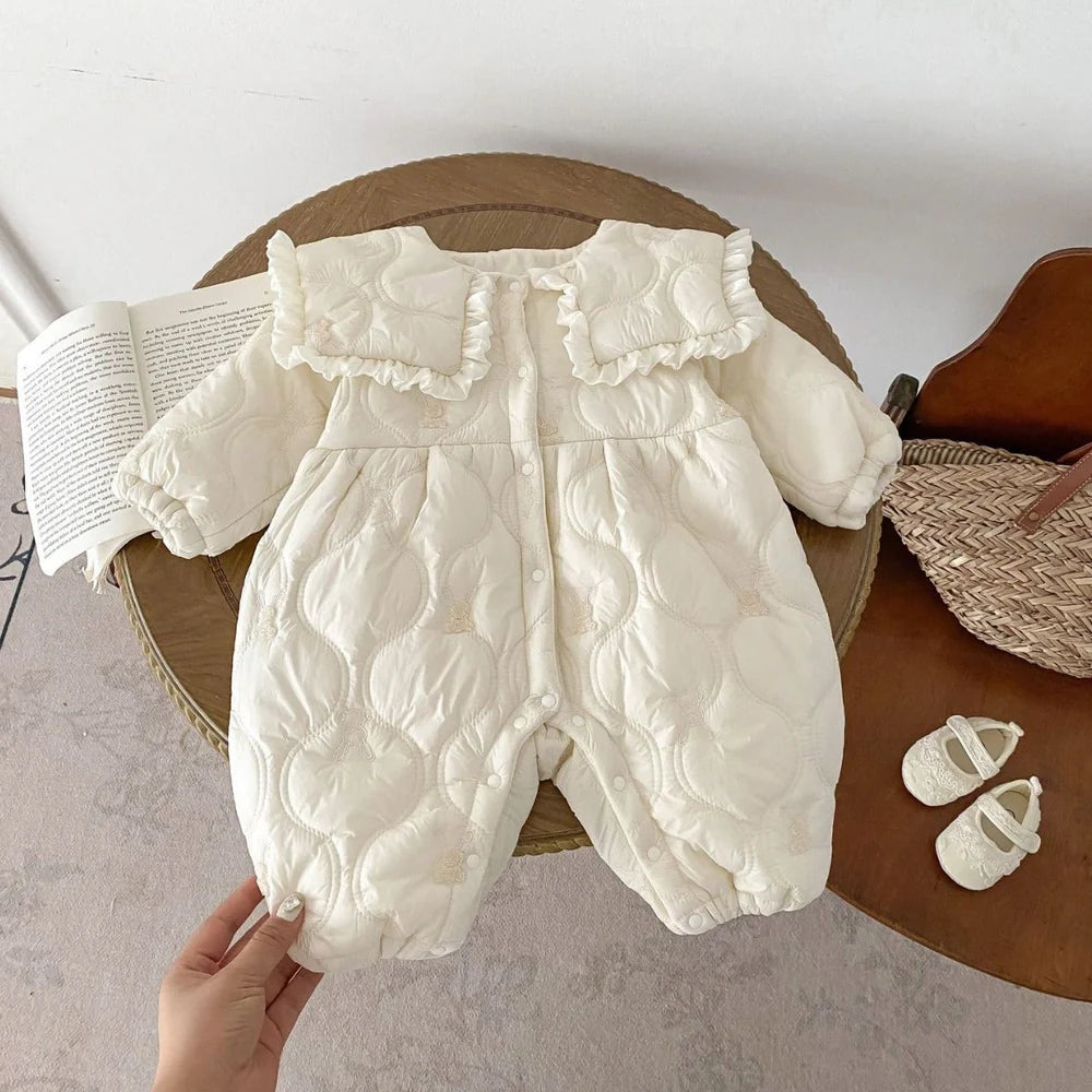 Newborn in light beige fleece-lined quilted cotton jumpsuit with single-breasted closure