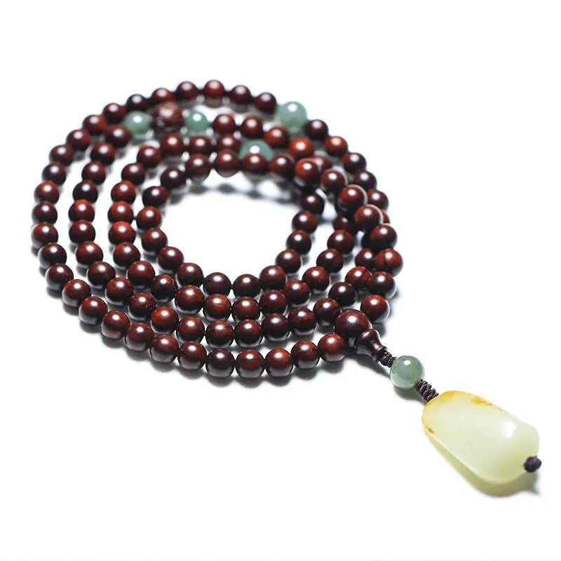 Rosewood bead bracelet with a carved wooden 108 bead and a green Hotian jade pendant on a neutral background.