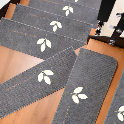 Self-adhesive luminous stair mat with glow strips on wooden staircase, rectangular design with hemmed edges