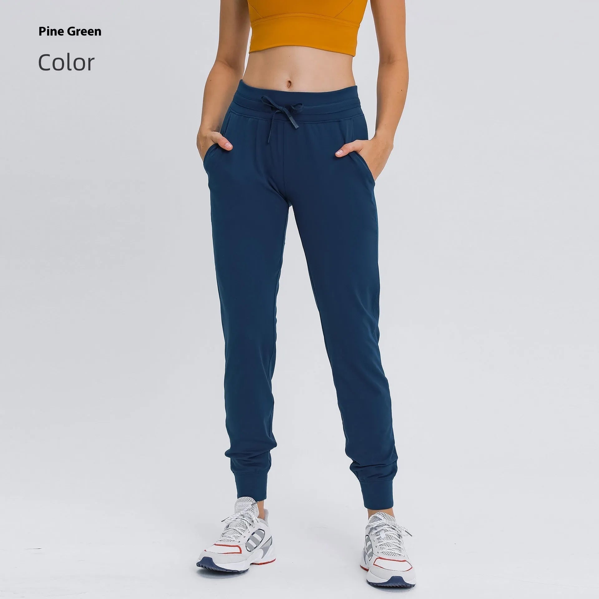 Women's high waist yoga pants with drawstring waistband in Belgian blue colour, showing stretch fabric during yoga pose