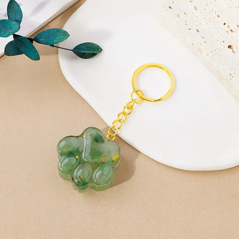 Natural crystal cat's paw keychain pendant showing gemstone options with integrated attachment loop