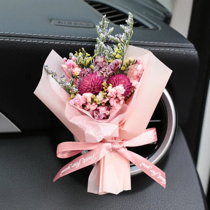 Mini dried flower bouquet mounted in car air vent for decorative aromatherapy