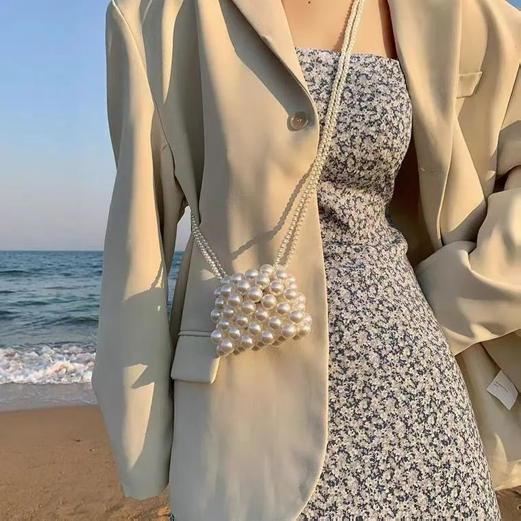 Women's imitation pearl mini crossbody handbag with geometric pattern in a pearl colour.