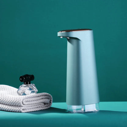 White automatic foam soap dispenser with infrared sensor on a bathroom countertop.