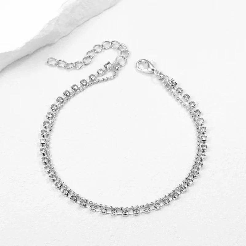 Women's geometric bead anklet with adjustable chain in gold and silver options.
