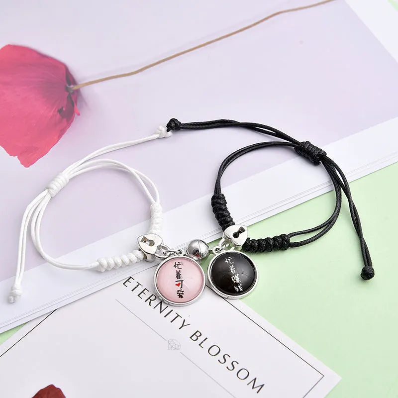 Magnetic suction couple bracelet pair in alloy with an electroplated finish, showing example designs like a crown and love lock.