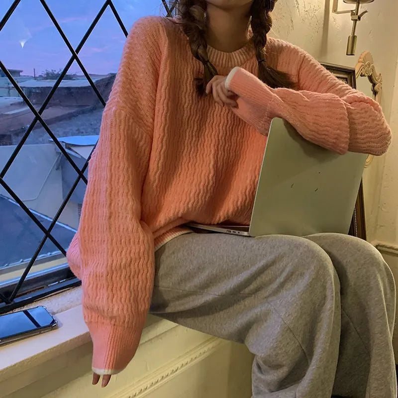 Women's loose blue pullover sweater with regular sleeves, shown on a hanger.