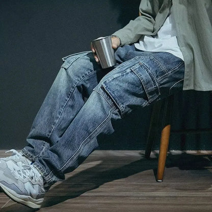Men's blue loose straight leg jeans with a zip fly, shown on a model.