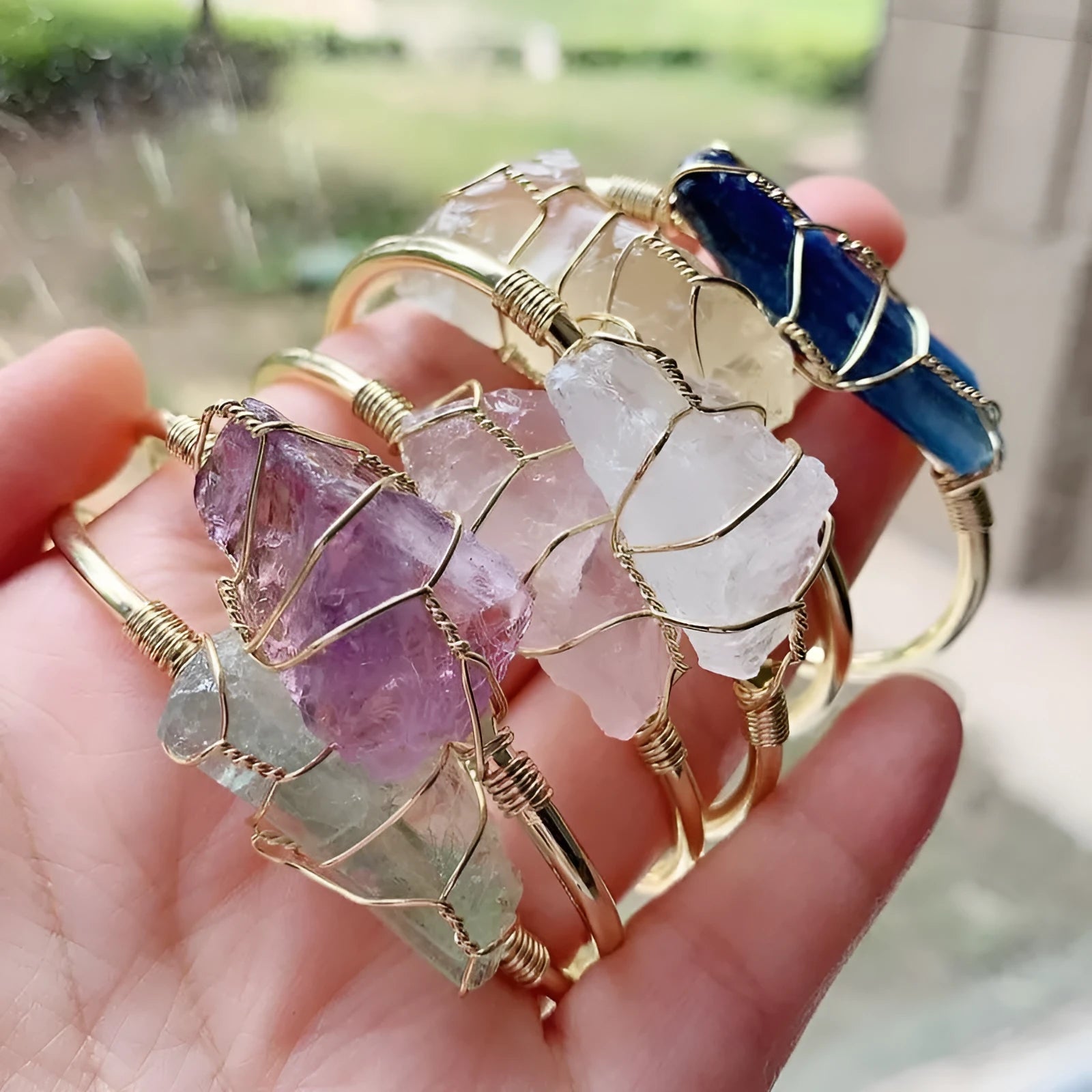 Unshaped natural crystal rough stone bracelet with gold winding metal accents in geometric design