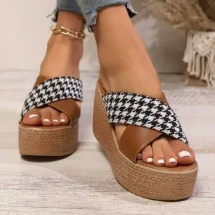 Brown and black cross leopard plaid pattern on casual wedge sandals with a rubber sole.
