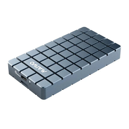 Silver aluminium alloy USB4 hard disk enclosure for M.2 SSDs, shown next to a laptop.